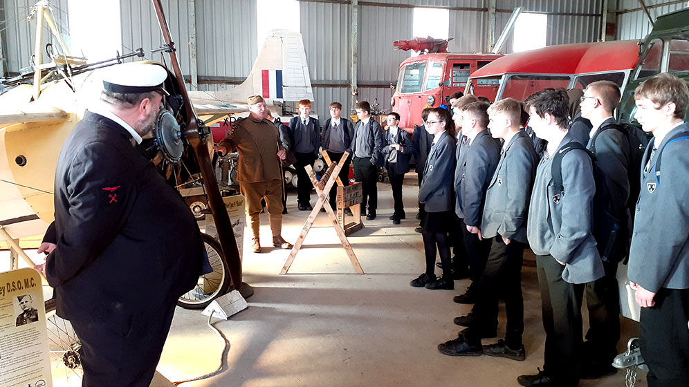 Students listening to a talk in a transport museum